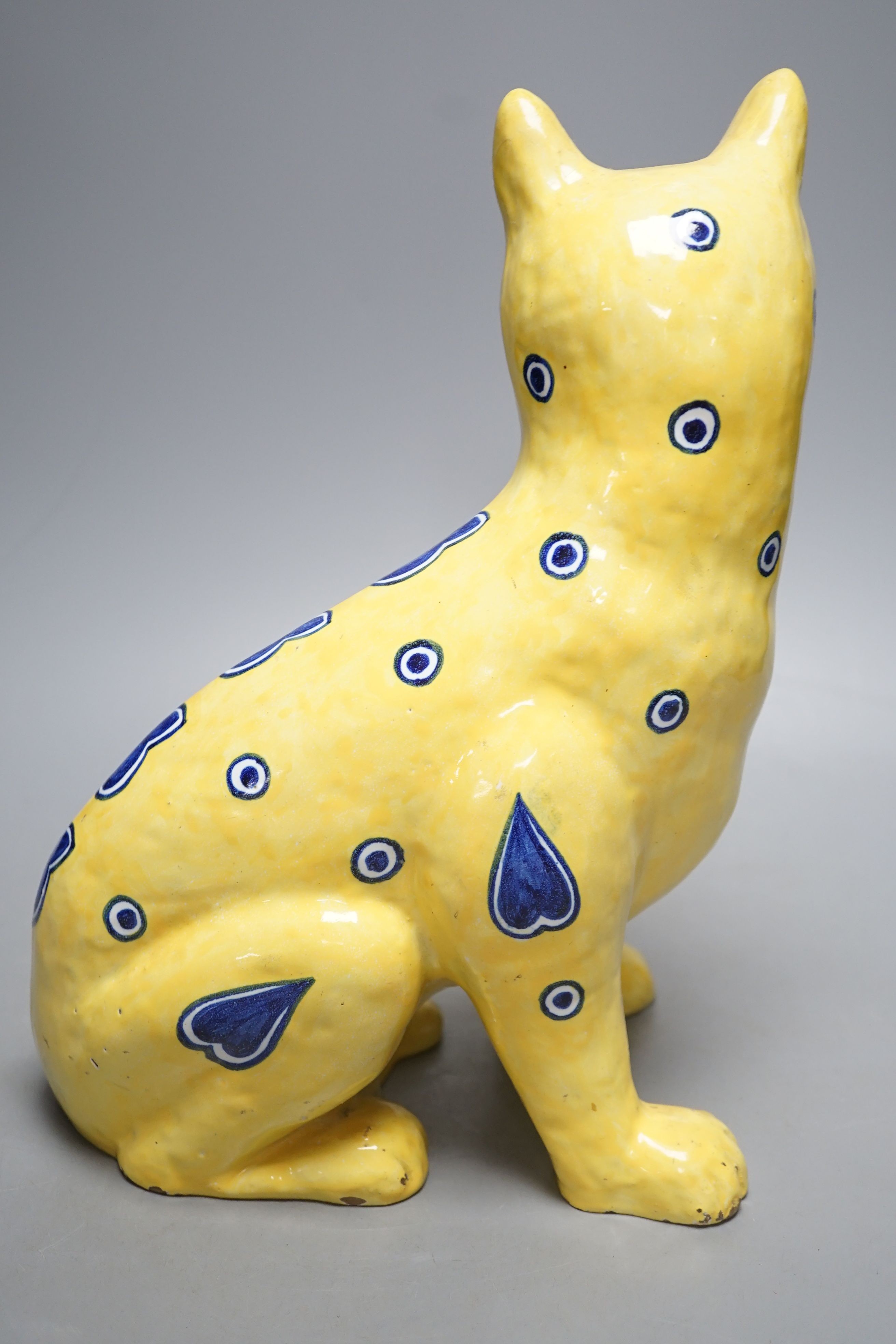 A Mosanic Galle style seated yellow and blue faience cat - 31cm tall